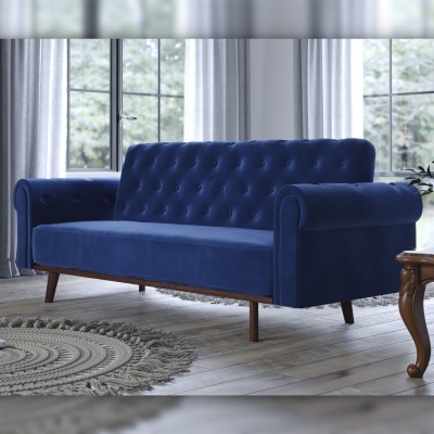 sofá azul escuro de veludo com botões e pés de madeira numa sala luminosa