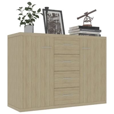 Cômoda de madeira clara com gavetas e portas, decorada no topo com planta, moldura, livros e objeto decorativo