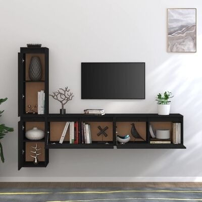 Estante modular preta de parede com livros, decorações e planta, televisão montada na parede clara