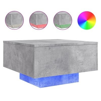Mesa de centro quadrada em betão cinzento com base iluminada azul e círculos coloridos destacando acabamentos.