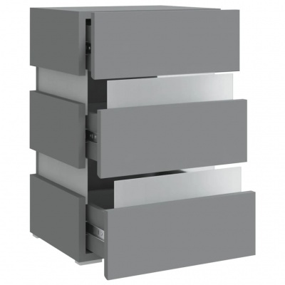 Cômoda cinza com três gavetas abertas