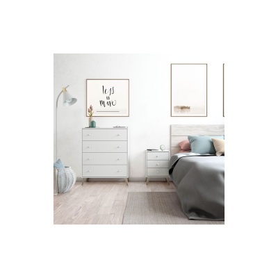 Quarto com cómoda branca e cama cinzenta com almofadas coloridas