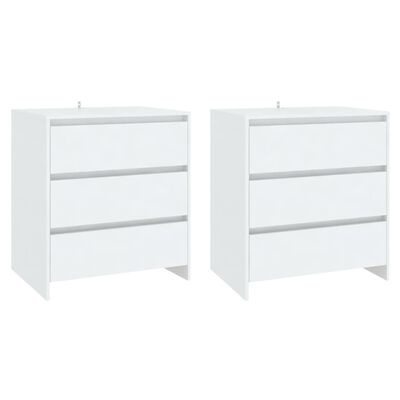 Duas mesas de cabeceira brancas com três gavetas cada em fundo branco