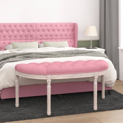 Banco estofado oval rosa em madeira branca junto a cama com cabeceira rosa