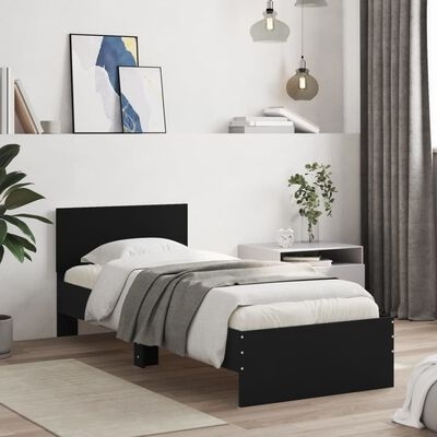 Cama individual preta com edredão branco e manta cinza num quarto moderno