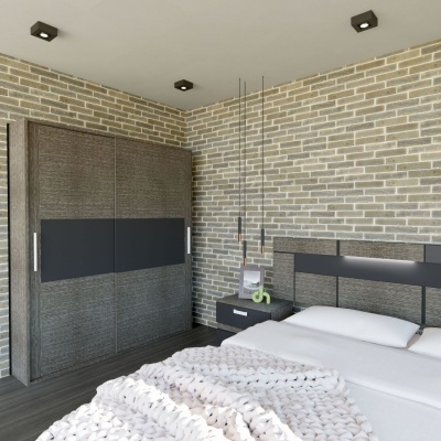 Quarto moderno com armário de madeira escura e cama com cabeceira preta em parede de tijoleira cinza