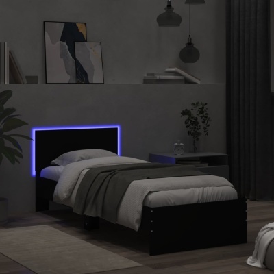 Cama individual preta com cabeceira iluminada em luz azul numa divisão minimalista