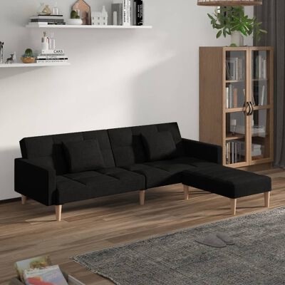 sofá chaise longue preto com almofadas numa sala com estante de madeira e prateleira branca