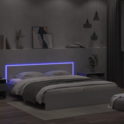 Cama branca moderna com cabeceira iluminada por luz LED azul em quarto cinzento