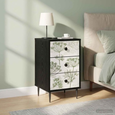 Mesa de cabeceira preta com três gavetas decoradas com padrão floral verde junto a cama cinza