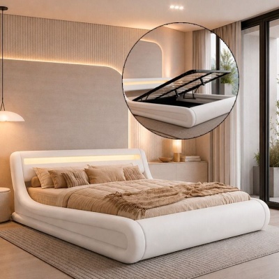 Cama branca estofada com iluminação na cabeceira e sistema de arrumação, em quarto moderno e bem iluminado.