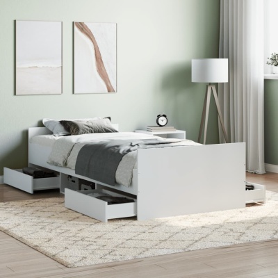 Cama branca com gavetas abertas e decoração minimalista num quarto moderno