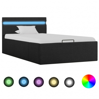 Cama estofada preta com luz LED azul na cabeceira e almofada branca