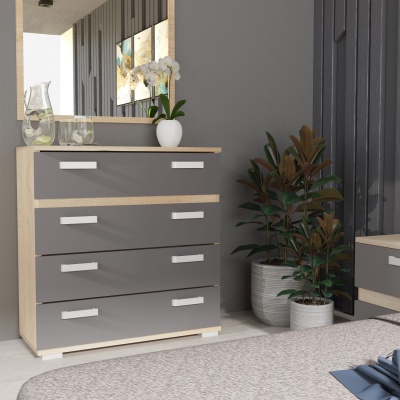 Cômoda cinza com quatro gavetas e puxadores brancos num quarto cinzento com plantas e decoração