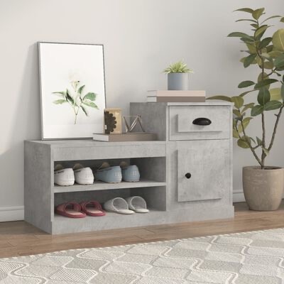Móvel cinza claro com sapatos, gaveta, porta, livros, planta, vela e quadro decorativo numa sala