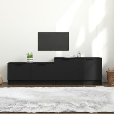 Móvel preto minimalista com plantas e decoração num espaço interior claro