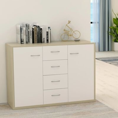 Aparador de madeira clara com portas e gavetas brancas, livros e escultura de bicicleta dourada em cima, interior claro.