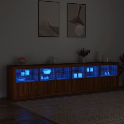 Aparador de madeira com vidro iluminado a azul e louças brancas numa sala com decoração minimalista
