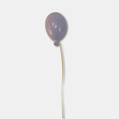 Balão lilás amarrado a um fio branco sobre fundo branco