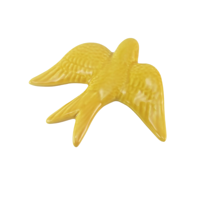 Figura decorativa amarela em forma de pássaro com textura detalhada.