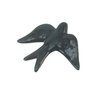 Estatueta preta de pássaro com asas abertas