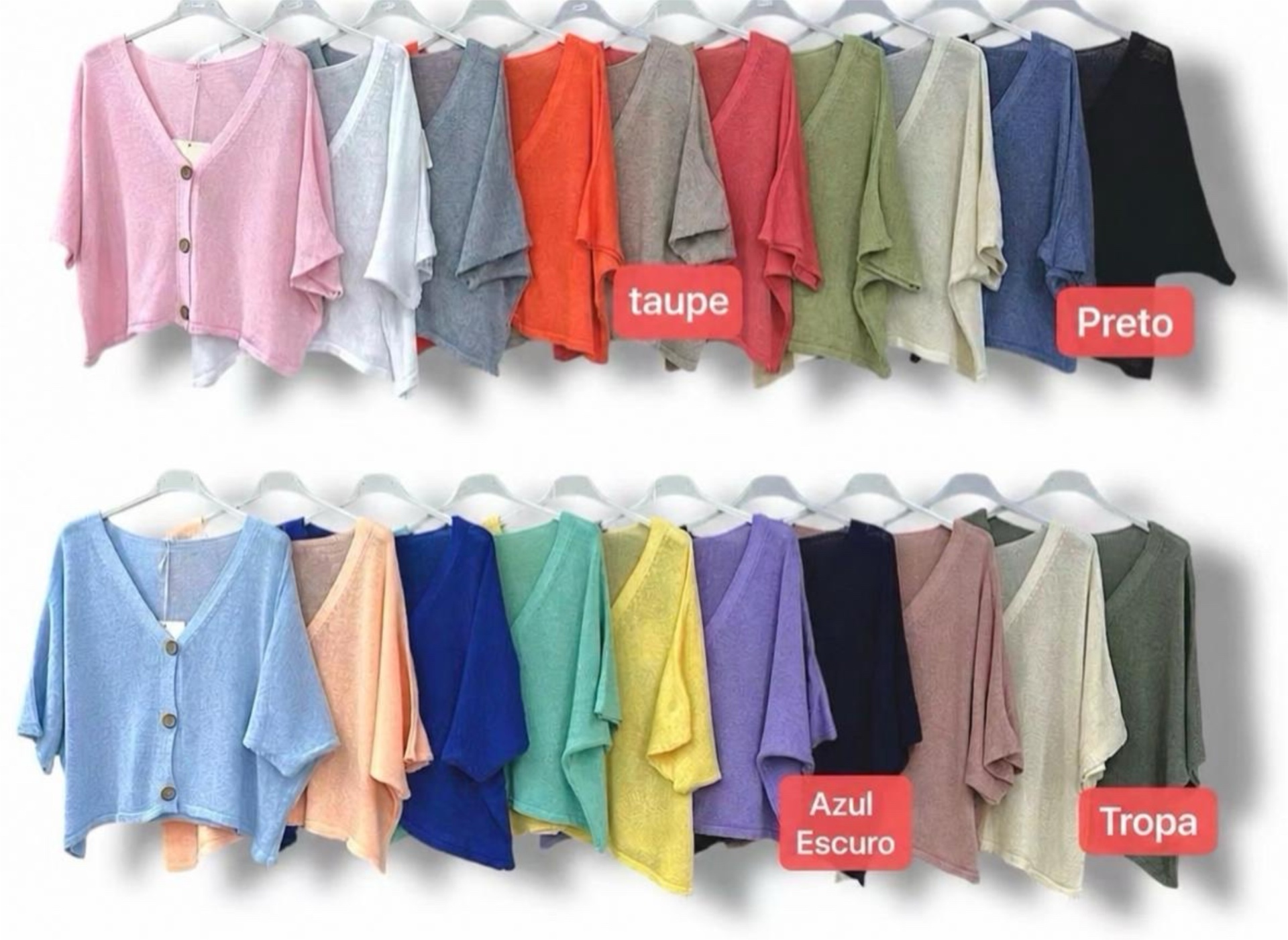 Casacos coloridos de malha leve com botões pendurados em cabides.