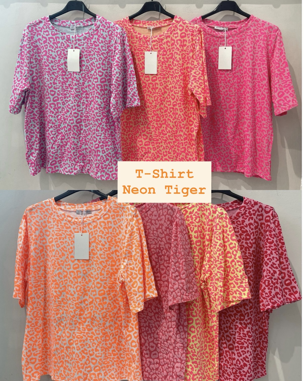 Sete t-shirts com padrão animal em cores neon penduradas