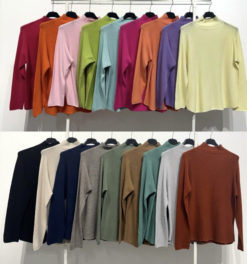 Camisolas de malha com gola alta em várias cores penduradas em cabides
