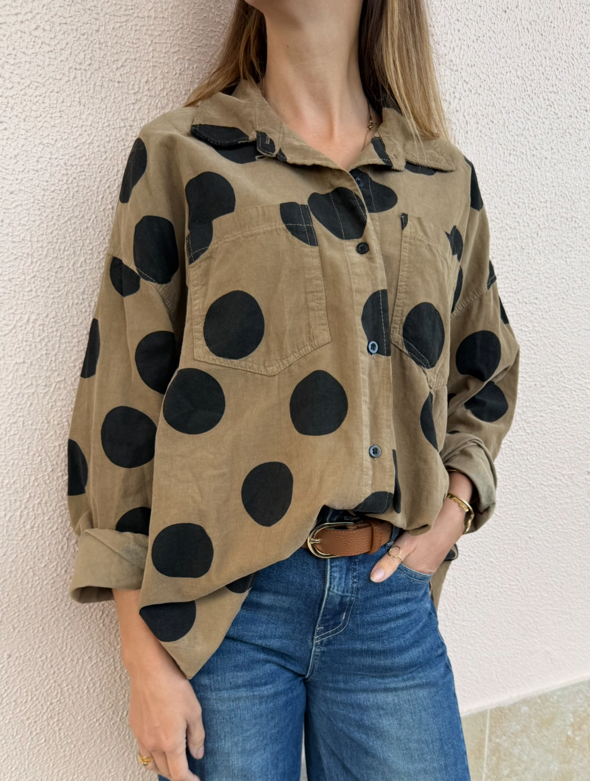 Camisa castanha com bolinhas pretas e bolso, usada com jeans e cinto castanho
