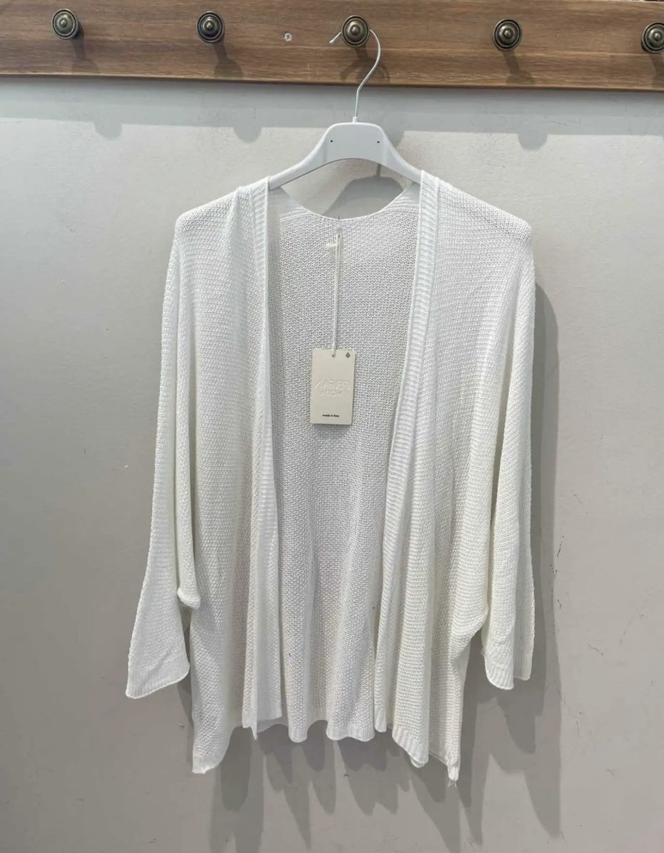 Casaco aberto branco de malha leve pendurado numa cabide