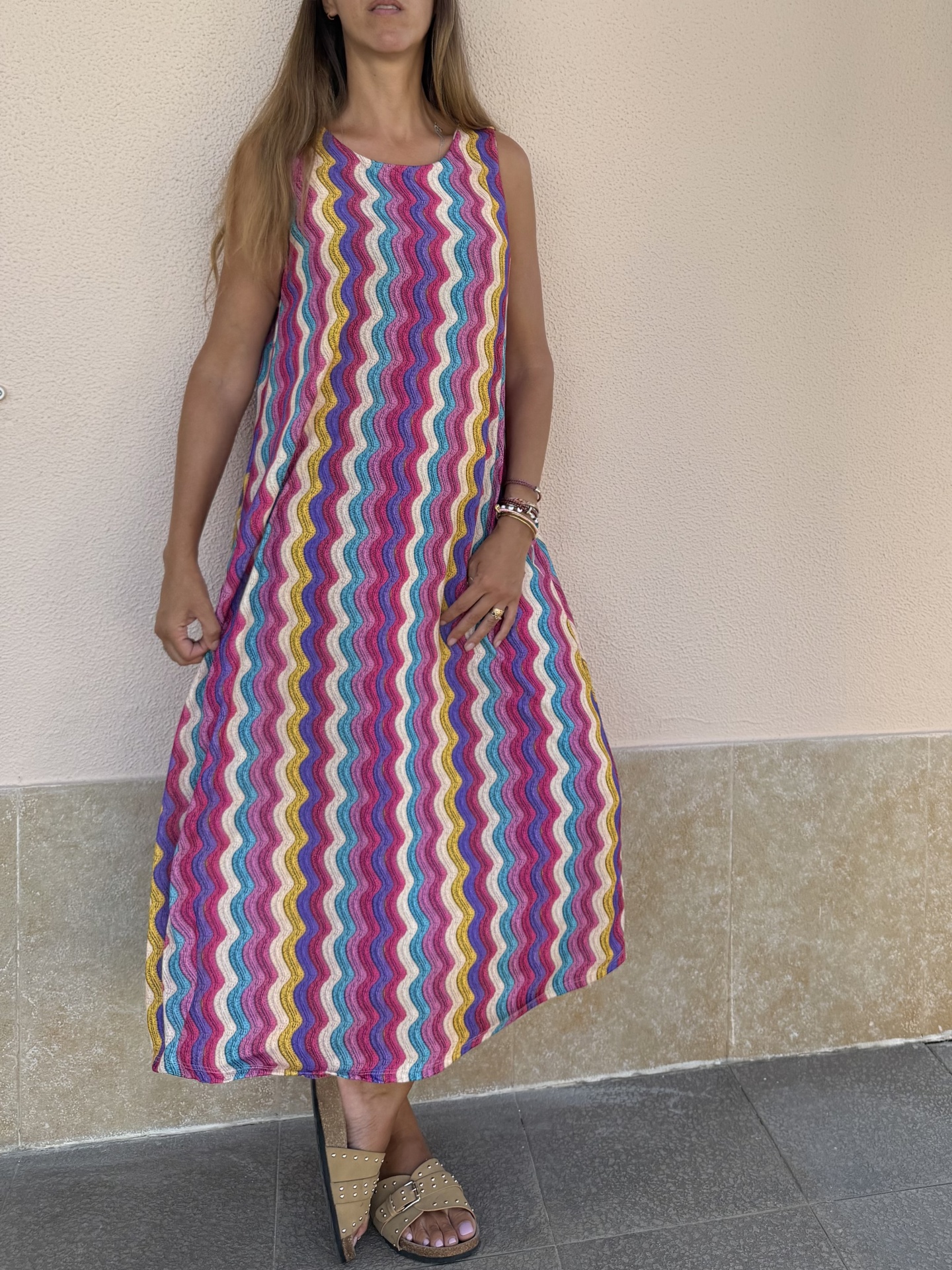 Vestido comprido colorido com padrão ondulado usado por mulher