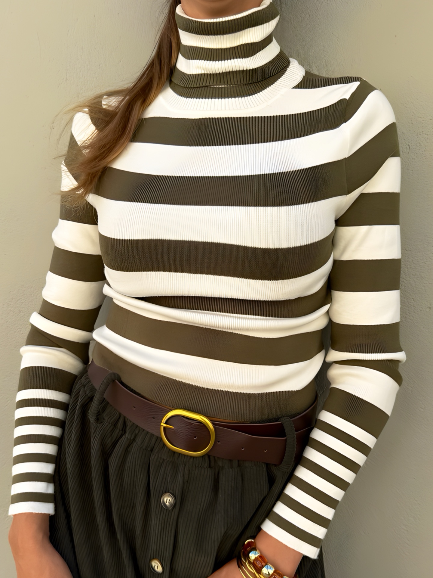 Gola alta riscada branca e verde-oliva com calças caneladas verdes e cinto castanho