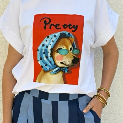 T-shirt branca com estampa de cão com lenço azul e óculos, calças de riscas azuis.