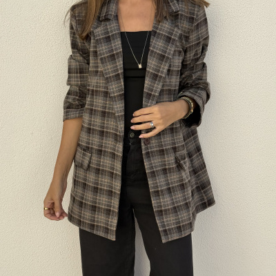 Blazer xadrez em tons castanhos usado por mulher com top preto e calças pretas
