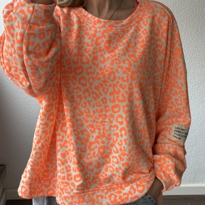 Sweatshirt padrão leopardo bege e laranja fluorescente com etiqueta escrita na manga