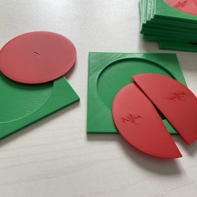 Material didático com discos vermelhos e bases verdes em mesa branca