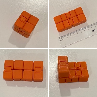 Blocos ou cubos laranja articulados sobre superfície branca com régua