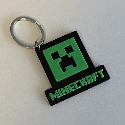 Porta-chaves com design do personagem Creeper do Minecraft em verde e preto
