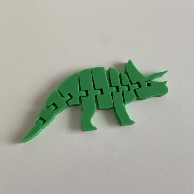 Dino puzzle verde em plástico sobre fundo branco