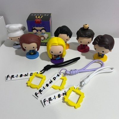 Figuras de vinil da série Friends e três pulseiras com etiqueta e texto FRiENDS.