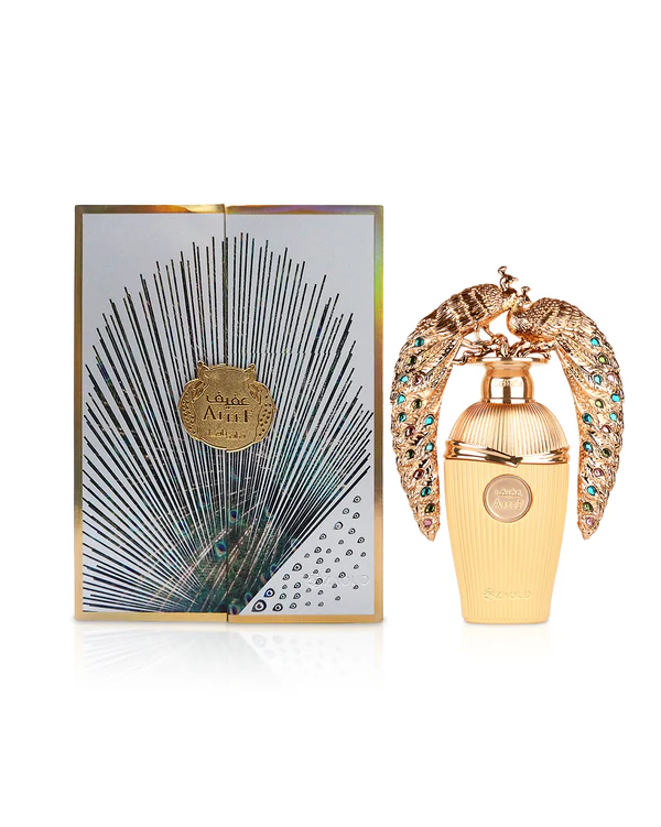 frasco de perfume dourado com duas aves decorativas e caixa branca com padrão de penas