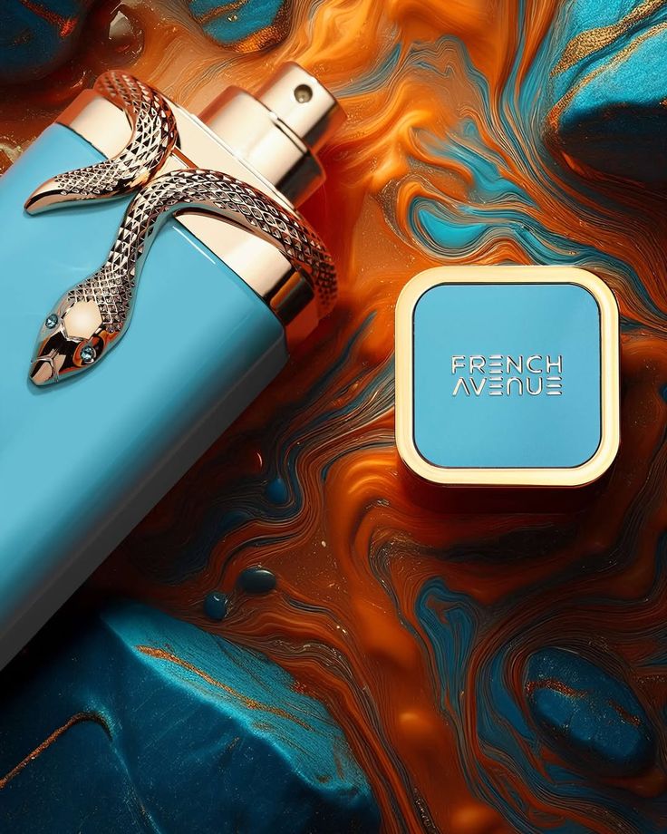 Frasco de perfume azul claro com tampa azul e dourada e detalhe de serpente prateada