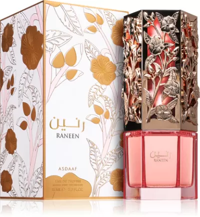 Frasco rosa de perfume com tampa decorativa dourada e embalagem com ilustrações florais