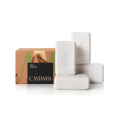 Quatro barras de sabonete branco com caixa de cartão castanha, verde e preta com texto