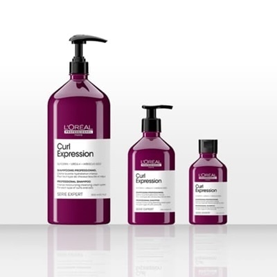 Três frascos roxos de produtos L'Oréal Curl Expression distintos tamanhos com etiquetas brancas