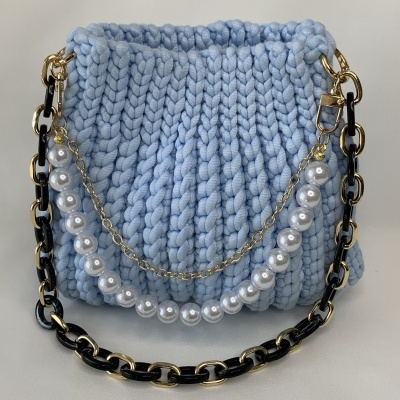 Bolsa tricotada azul claro com alça de corrente preta e dourada com pérolas
