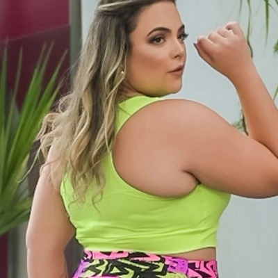 Top desportivo verde fluorescente sem mangas e leggings coloridas com padrão geométrico.