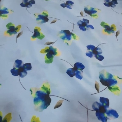 Tecido com padrão de flores azuis e verdes