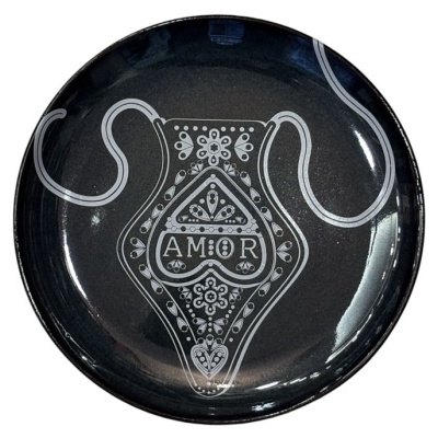 Prato preto decorativo com padrão branco e palavra AMOR.