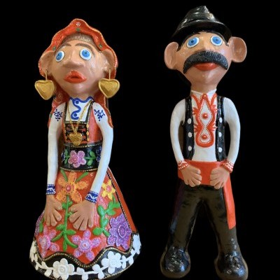 Duas figuras em cerâmica com trajes tradicionais coloridos